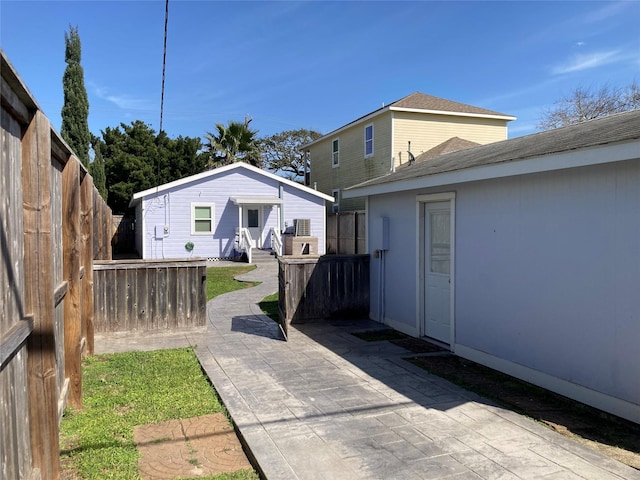 view of yard with an outbuilding, a patio area, and a fenced backyard