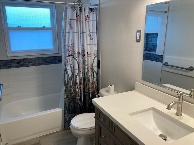 full bath with shower / tub combo, a textured wall, vanity, and toilet