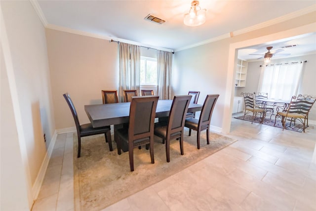 dining room with baseboards, visible vents, and crown molding