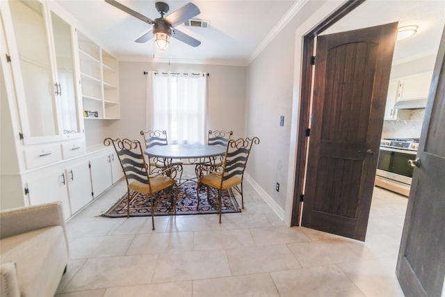 dining area with ornamental molding, visible vents, baseboards, and a ceiling fan