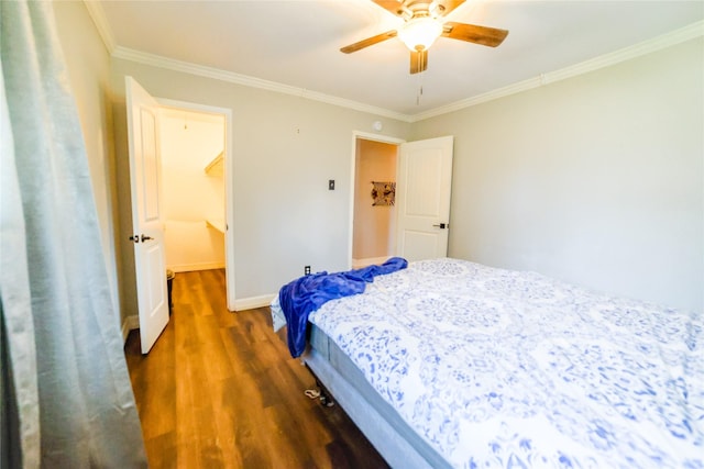 bedroom with ornamental molding, a ceiling fan, baseboards, and wood finished floors