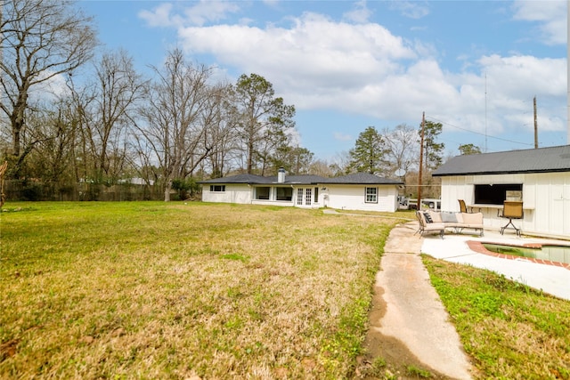 back of house with a lawn