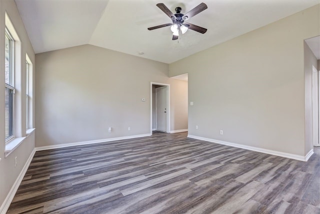 empty room with dark wood-style floors, lofted ceiling, baseboards, and a ceiling fan