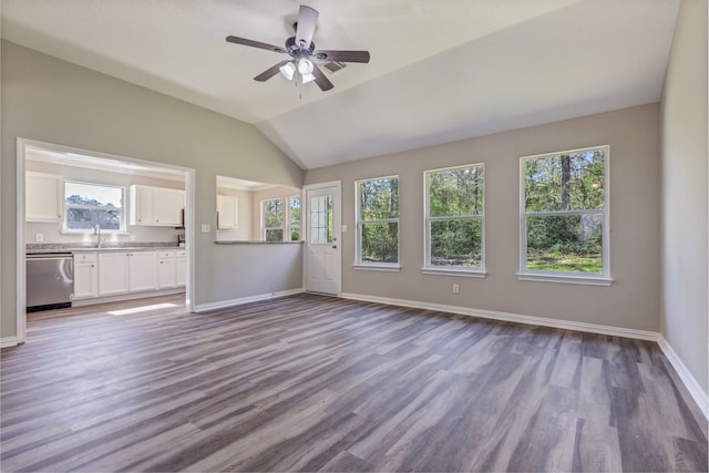 unfurnished living room featuring vaulted ceiling, dark wood-style flooring, and baseboards