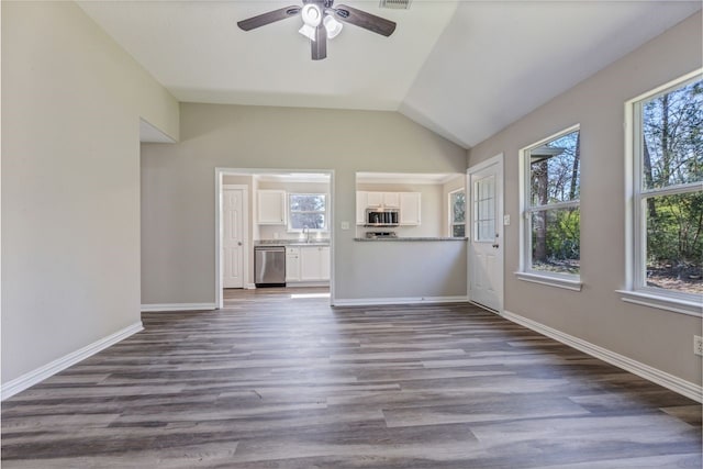 unfurnished living room featuring lofted ceiling, visible vents, dark wood-type flooring, a ceiling fan, and baseboards