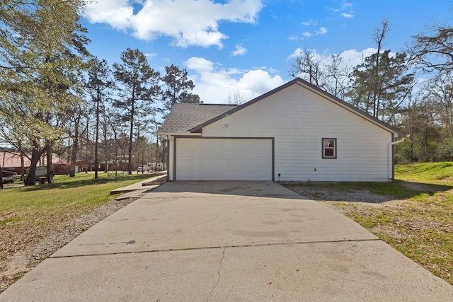 view of home's exterior featuring driveway, a shingled roof, a garage, and a yard