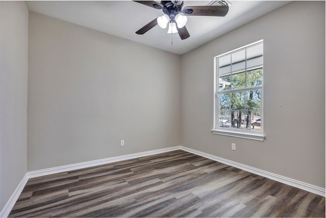 unfurnished room with dark wood-style flooring, ceiling fan, and baseboards