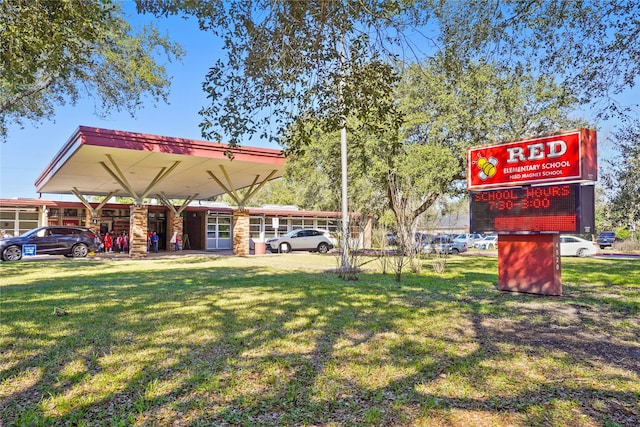 view of home's community featuring a carport and a lawn