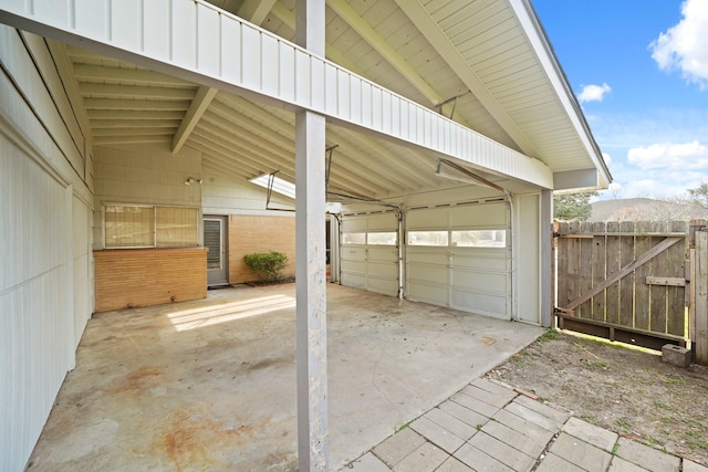 view of car parking featuring a carport and a gate