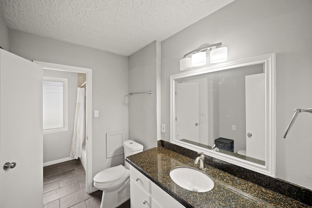 bathroom with shower / bathtub combination with curtain, toilet, vanity, and a textured ceiling