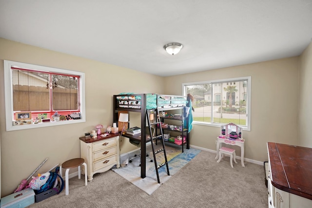 bedroom featuring light colored carpet and baseboards