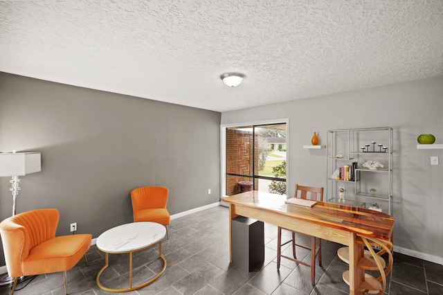 office area with baseboards and a textured ceiling