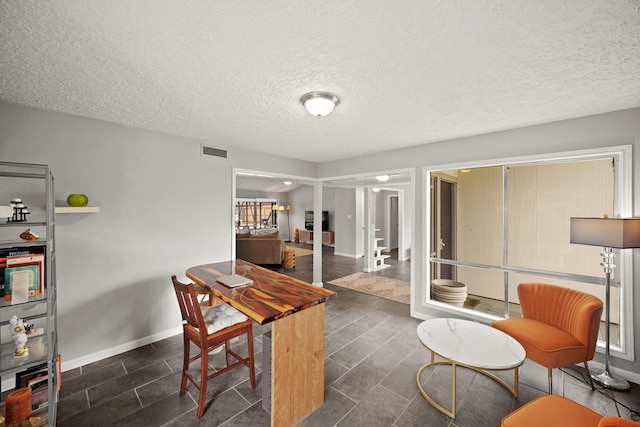 home office with visible vents, baseboards, and a textured ceiling