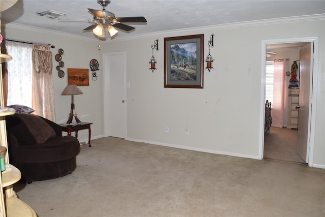 sitting room with ornamental molding, baseboards, visible vents, and carpet flooring