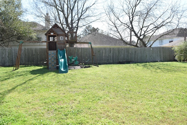 view of yard with a fenced backyard and a playground