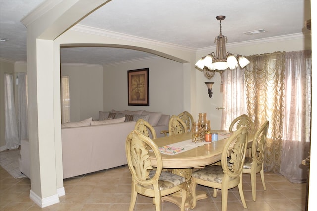 dining space with a chandelier, light tile patterned floors, arched walkways, visible vents, and ornamental molding