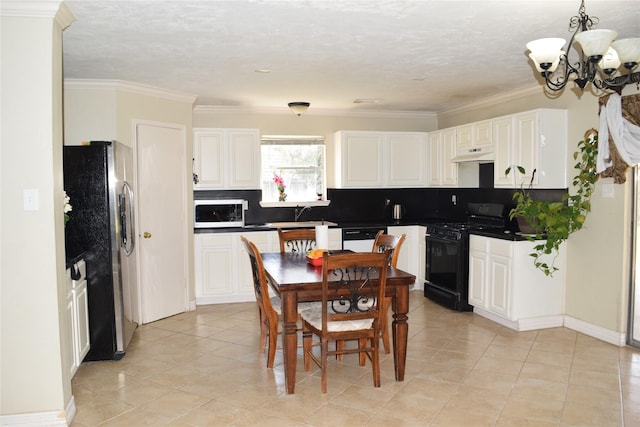 kitchen featuring black range with gas cooktop, dishwasher, dark countertops, freestanding refrigerator, and under cabinet range hood