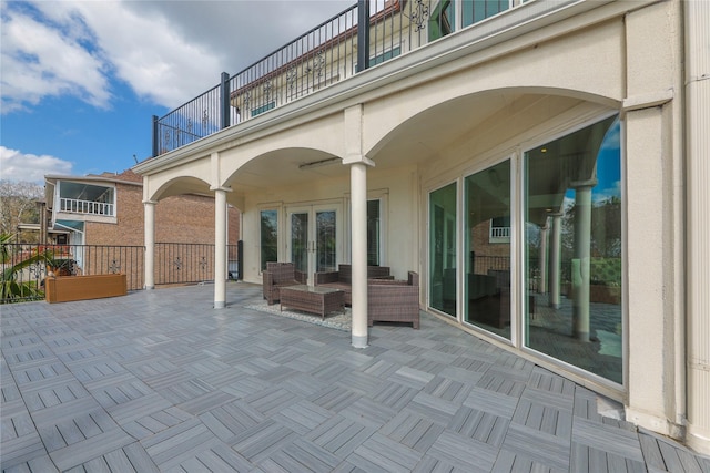 view of patio / terrace with french doors and a balcony