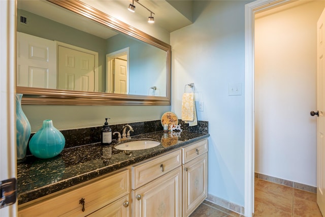 bathroom with tile patterned flooring, visible vents, vanity, and baseboards