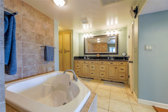 bathroom with a garden tub, double vanity, visible vents, a sink, and tile patterned floors