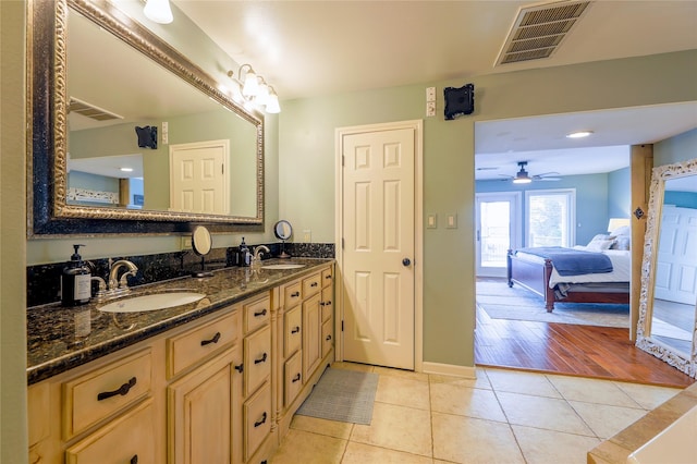 bathroom with double vanity, visible vents, connected bathroom, tile patterned floors, and a sink