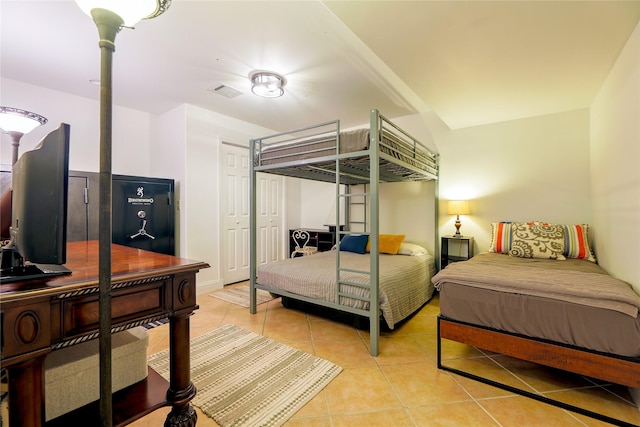 bedroom with light tile patterned floors and visible vents