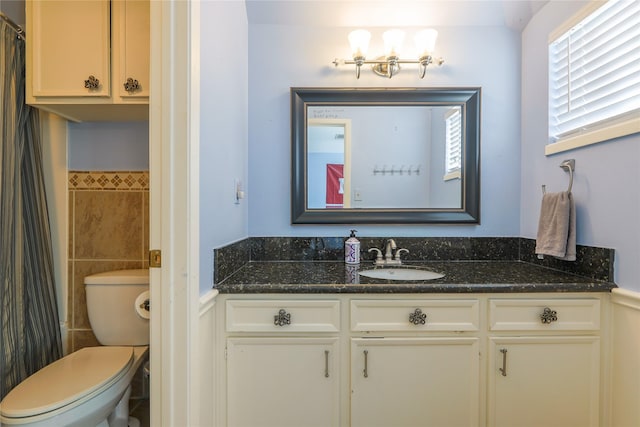 bathroom featuring vanity and toilet