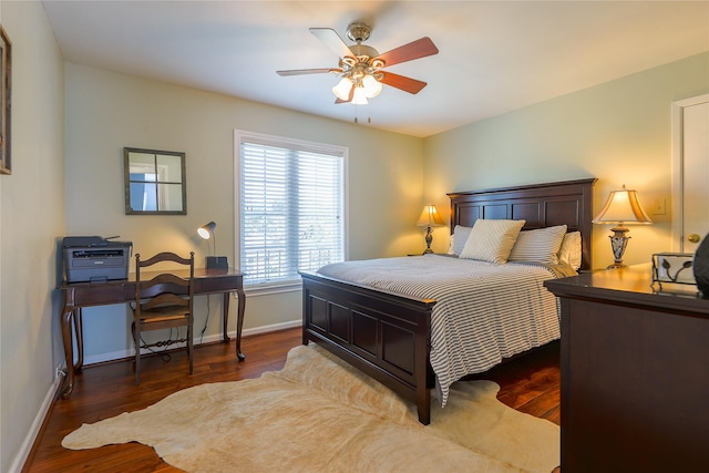 bedroom with a ceiling fan, baseboards, and wood finished floors