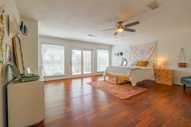 bedroom featuring access to outside, visible vents, ceiling fan, and dark wood-type flooring