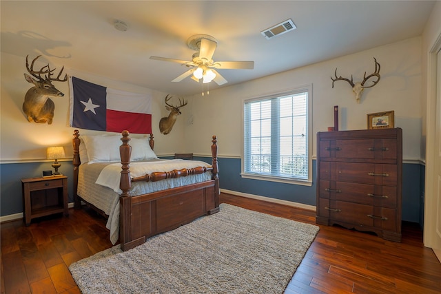 bedroom featuring a ceiling fan, baseboards, visible vents, and hardwood / wood-style floors