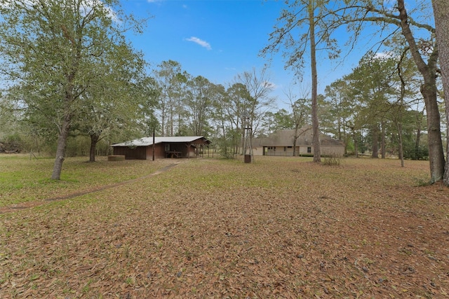 view of yard featuring an outbuilding and an outdoor structure