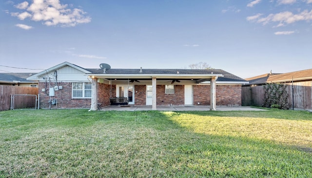 back of house featuring a patio area, ceiling fan, a fenced backyard, and a lawn