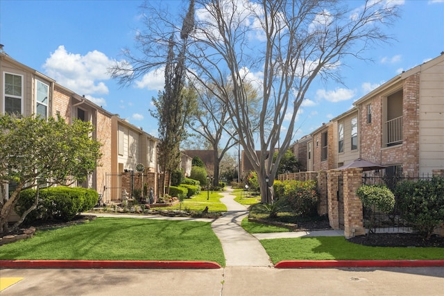 surrounding community featuring a residential view, a lawn, and fence