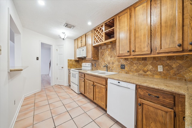 kitchen with visible vents, a sink, open shelves, tasteful backsplash, and white appliances