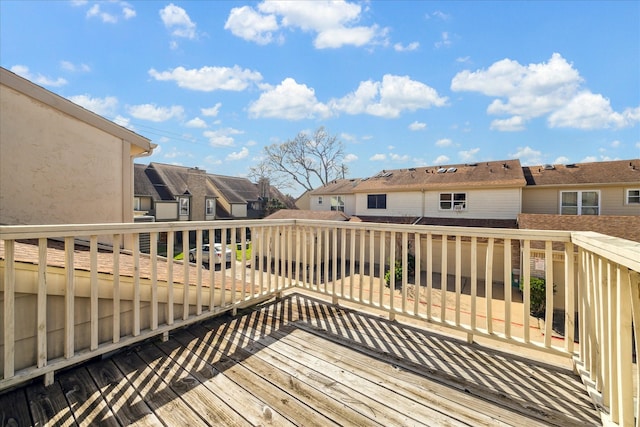 wooden terrace featuring a residential view