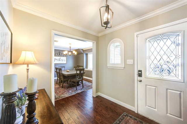 entrance foyer featuring a notable chandelier, ornamental molding, dark wood finished floors, and baseboards