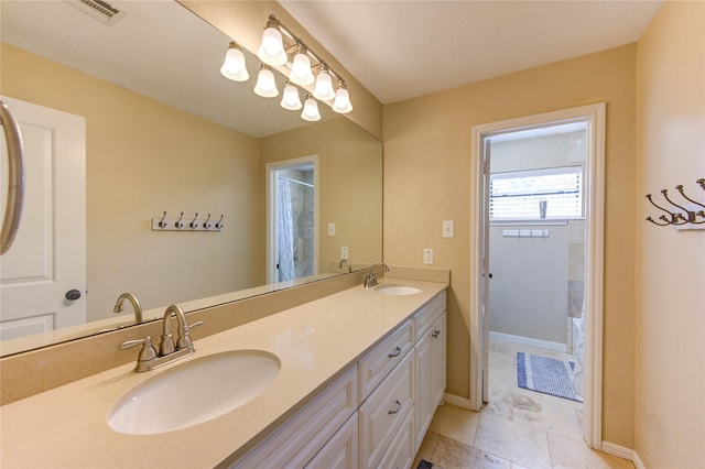 full bathroom with visible vents, a sink, baseboards, and double vanity