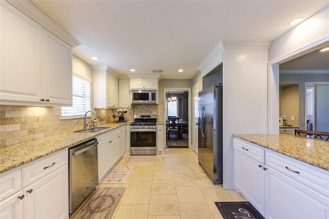 kitchen featuring white cabinetry, stainless steel appliances, and a sink