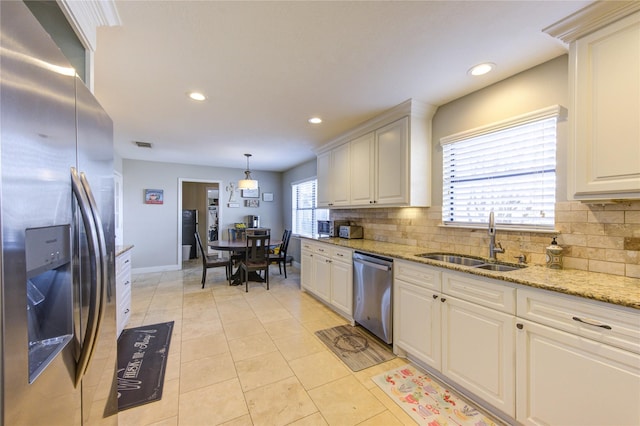 kitchen featuring light tile patterned floors, stainless steel appliances, recessed lighting, decorative backsplash, and a sink