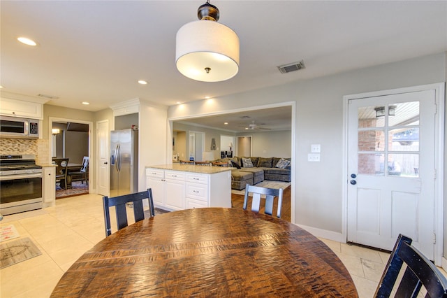 dining space with light tile patterned floors, baseboards, visible vents, and recessed lighting