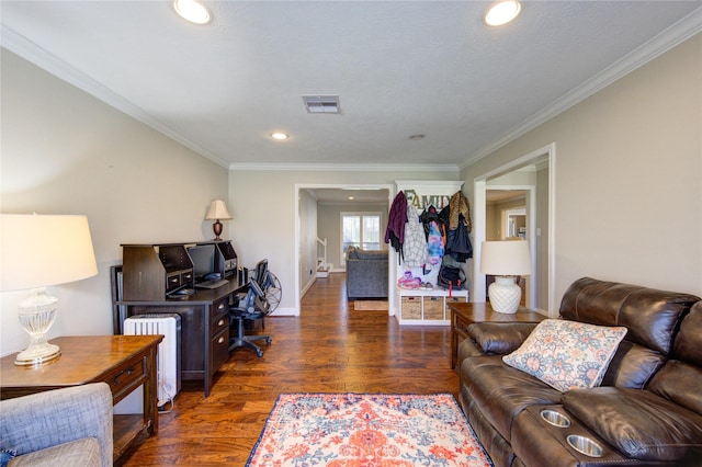 office space with visible vents, crown molding, baseboards, and wood finished floors