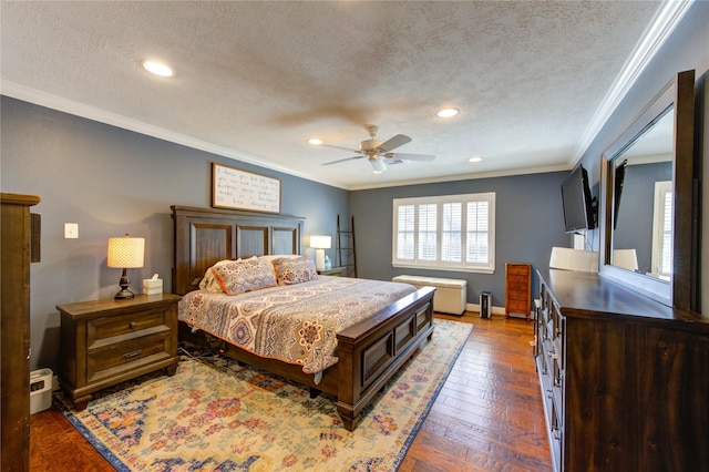 bedroom featuring a textured ceiling, ornamental molding, wood-type flooring, and baseboards