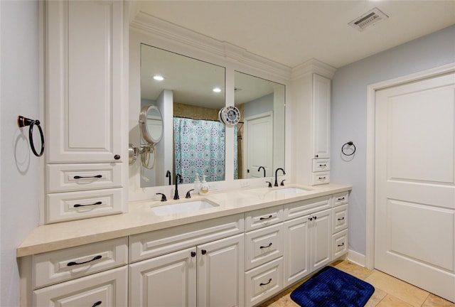 full bathroom with double vanity, tile patterned flooring, visible vents, and a sink