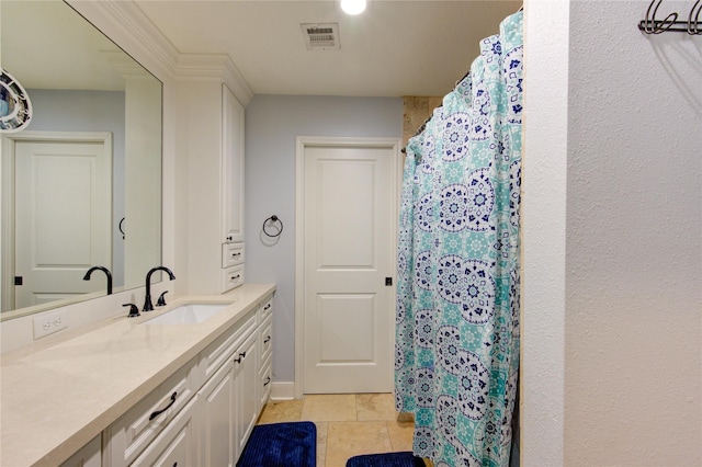 bathroom featuring baseboards, visible vents, vanity, and a shower with shower curtain