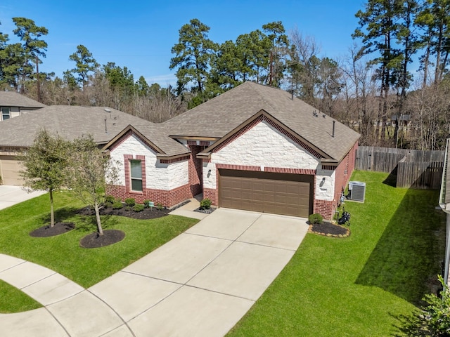 view of front of home featuring stone siding, brick siding, fence, and an attached garage