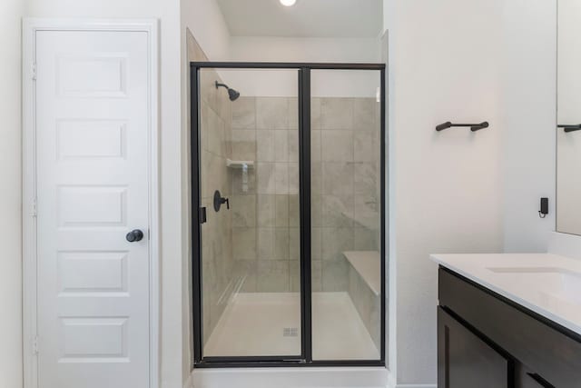 full bath with a shower stall and vanity