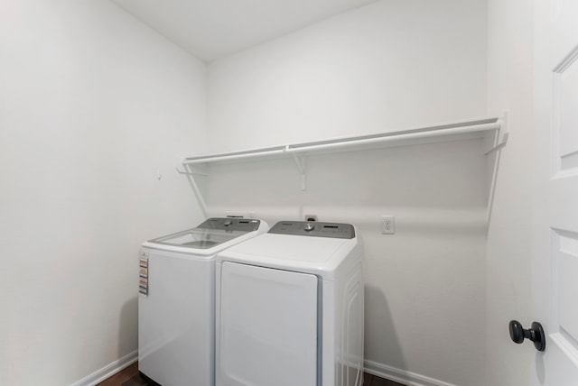 laundry room with laundry area, baseboards, and washer and clothes dryer