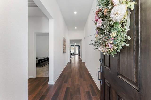 hallway featuring recessed lighting, dark wood finished floors, and baseboards