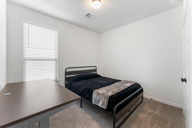 carpeted bedroom with baseboards and visible vents