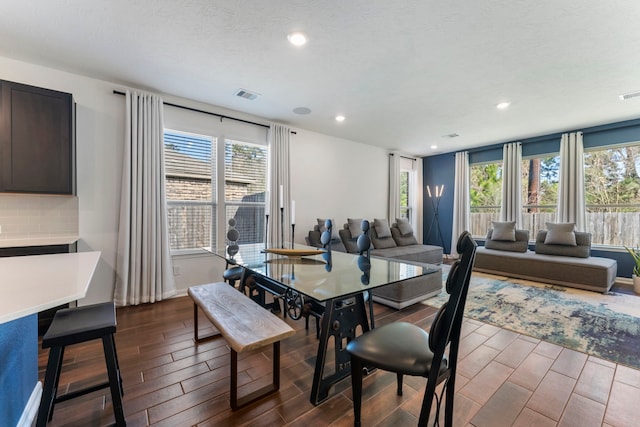 dining area with a wealth of natural light, wood finish floors, visible vents, and recessed lighting